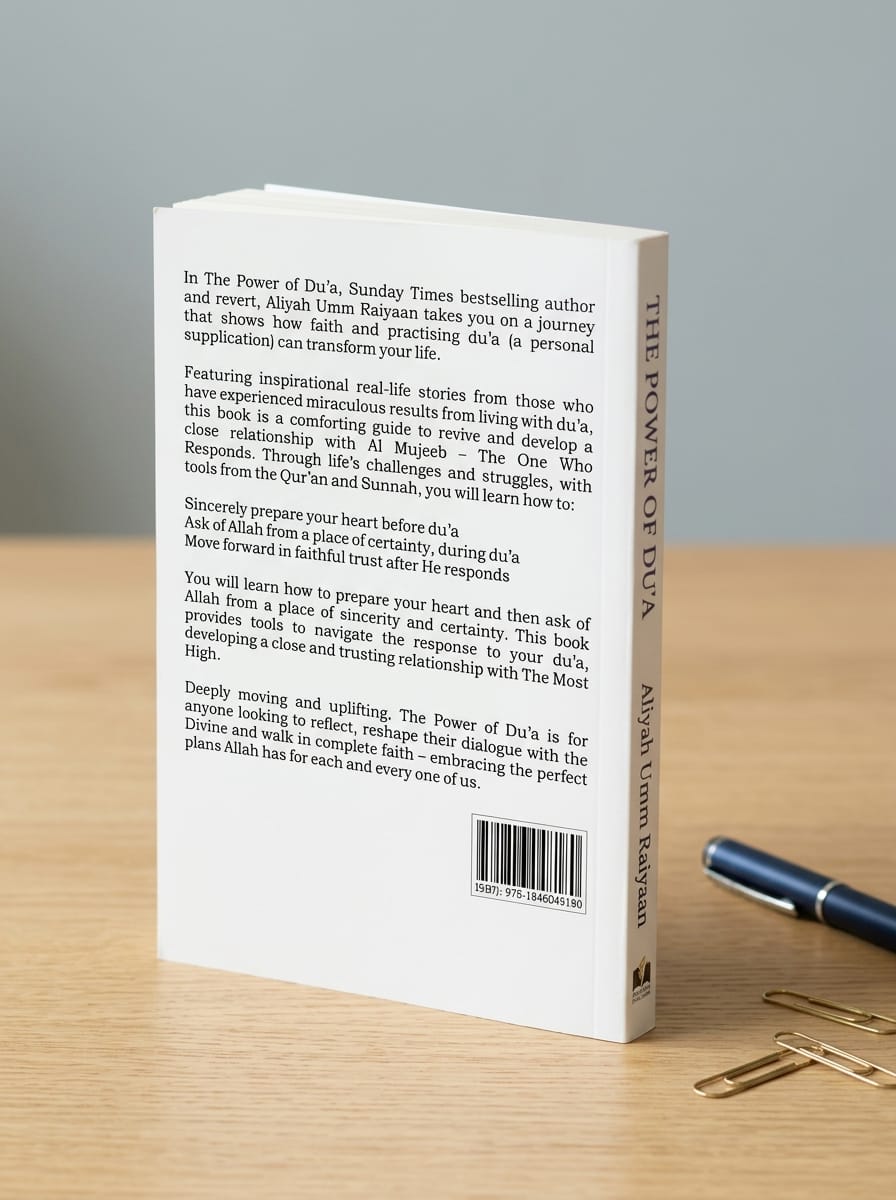 Book cover with text and a pen on a wooden surface