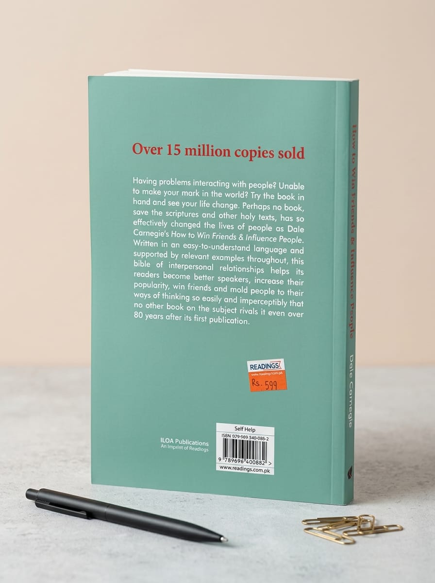 Book with a pen and paper clips on a light surface