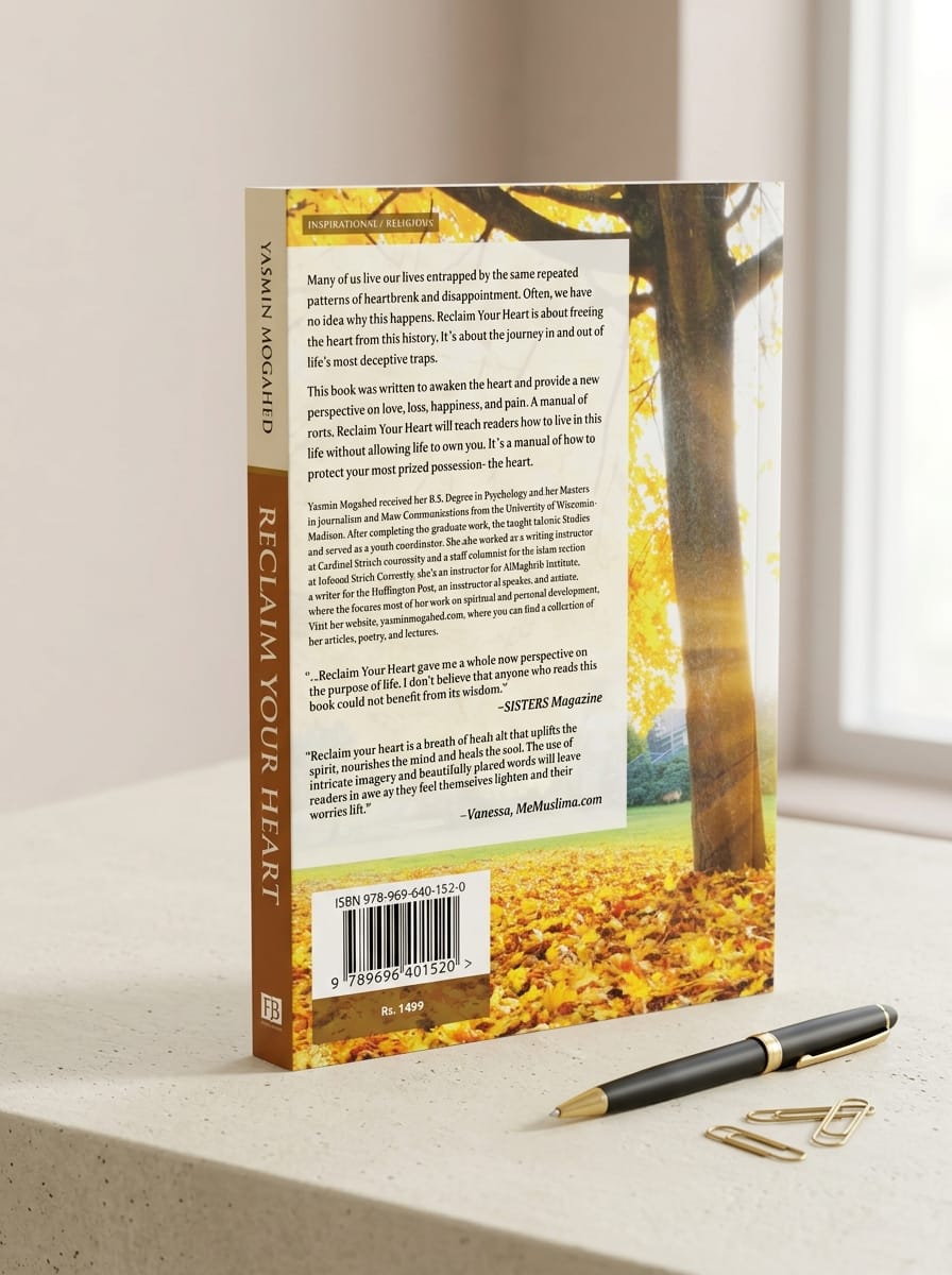 "Back cover of Reclaim Your Heart by Yasmin Mogahed showing book synopsis on emotional healing and spiritual freedom, author biography highlighting her psychology and journalism background, inspirational quotes from SISTERS Magazine and MeMuslima.com, ISBN barcode, price Rs 1499, and autumn leaf design, placed on a desk with a black fountain pen and paper clips"