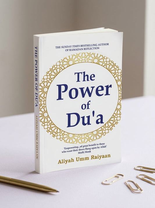 Book titled 'The Power of Du'a' by Aliyah Umm Raiyaan on a light surface with decorative elements.