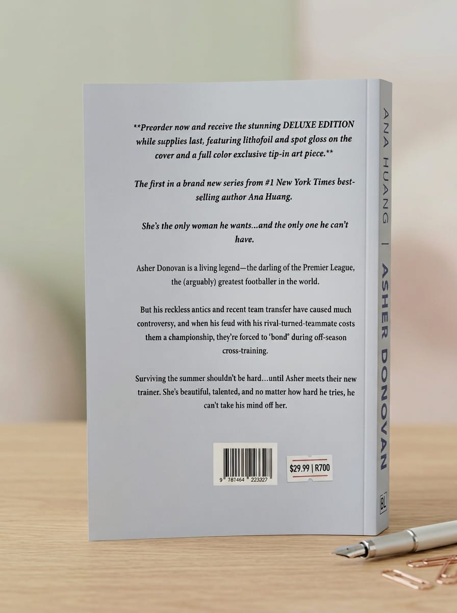 Book cover with text and a pen on a wooden surface