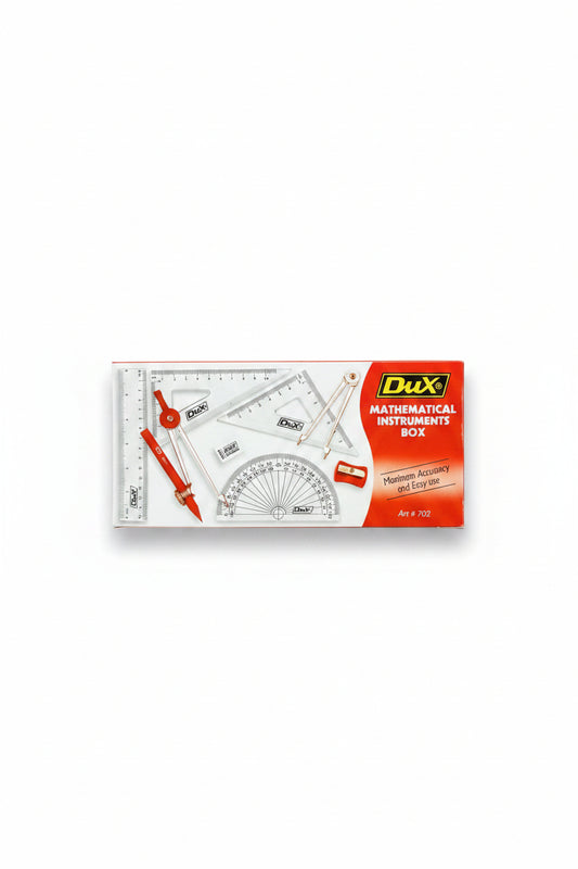 A hand holding a Dux brand mathematical instruments box containing drafting tools like a protractor, ruler, compass, and set square, with a blurred shop background.